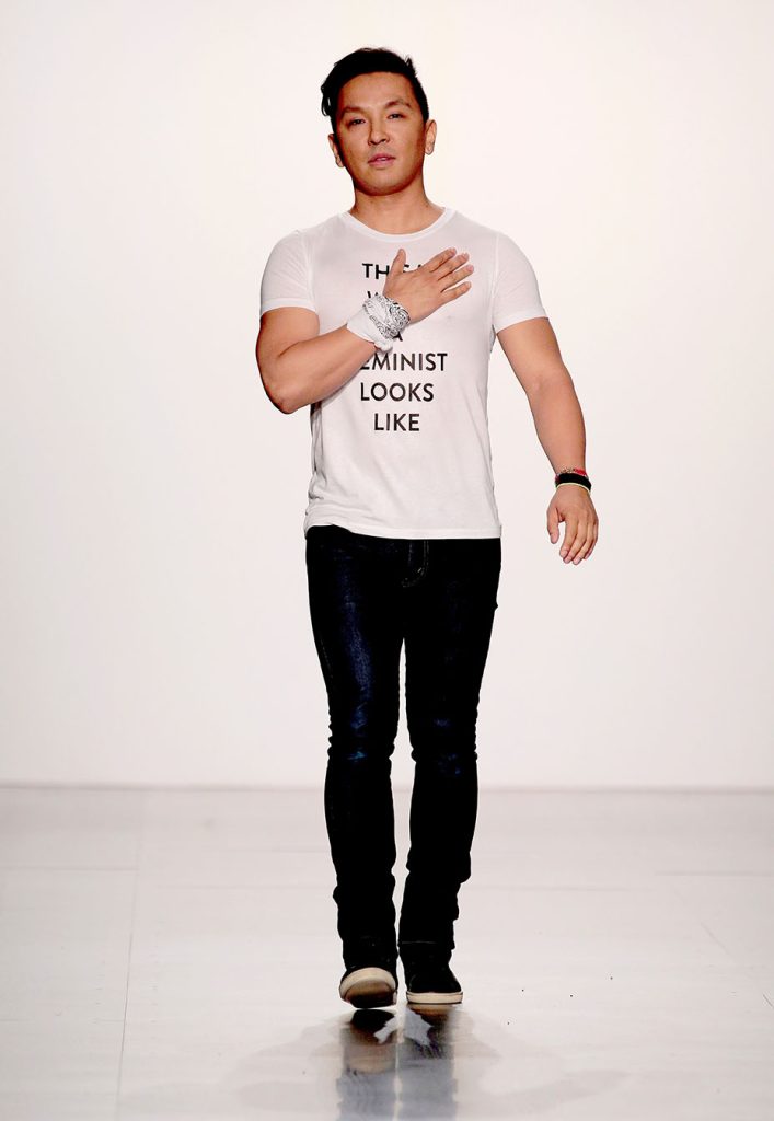 Prabal Gurung on catwalk wearing white t-shirt with black writing saying 'This is what a feminist looks like'.