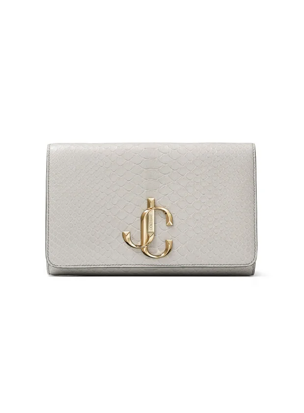 Grey snakeskin embossed wallet with gold JC hardware from Jimmy Choo on white background.