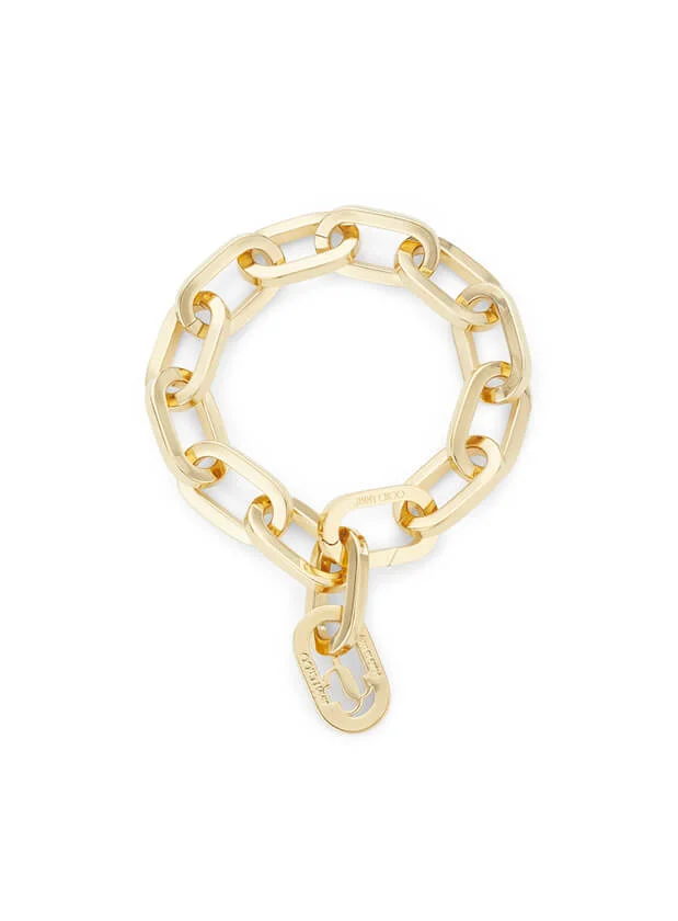 Gold chainlink bracelet by Jimmy Choo on white background.