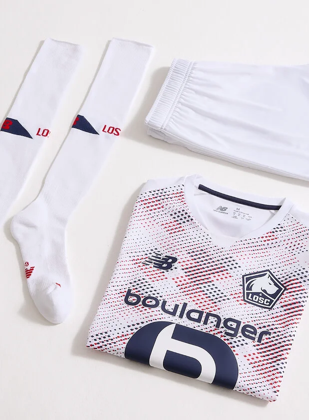 Flat lay image of New Balance sportswear including top, shorts and socks.