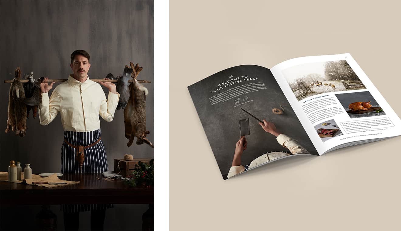 Butcher holding wooden bar with rabbits hanging off the end.