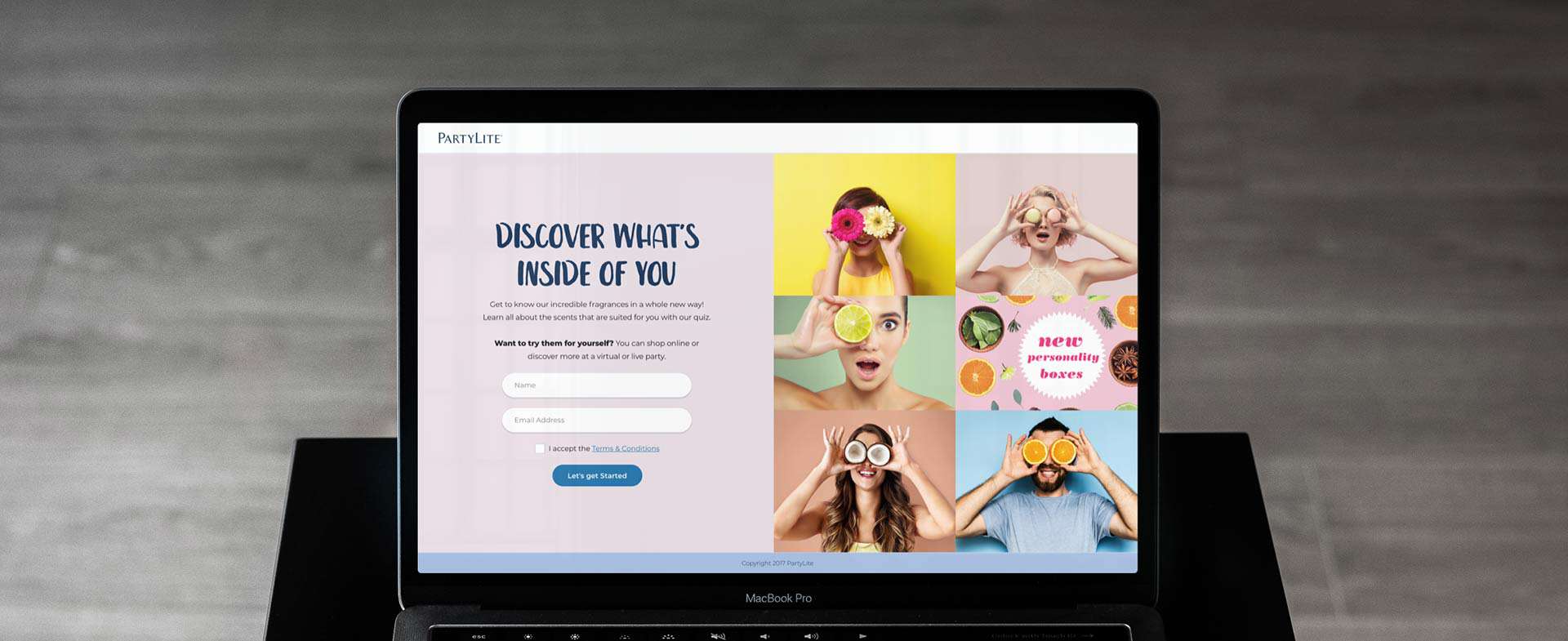 The screen of a macbook pro on a black table with grey wooden floor in background.