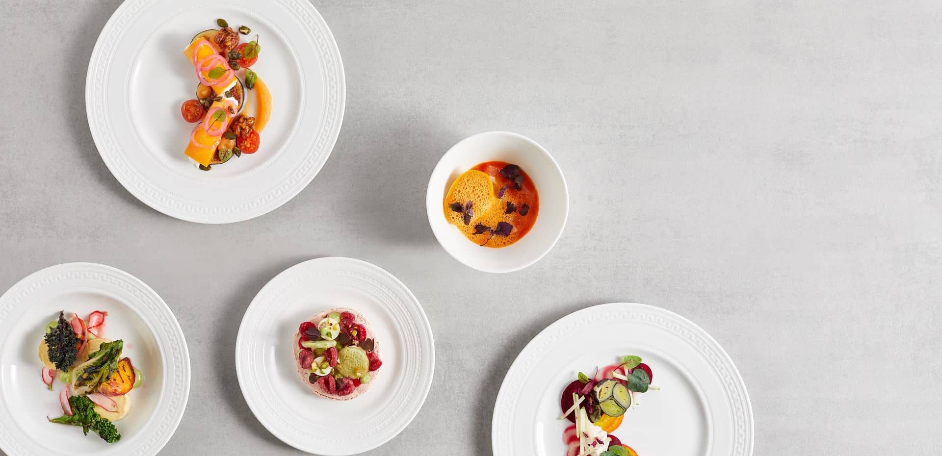 Wedgewood's Intaglio and Gio white bone china ranges with food on