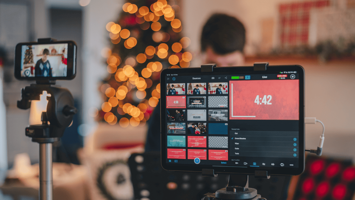 Mobile phone and tablet computer set up for filming a livestream on social media.