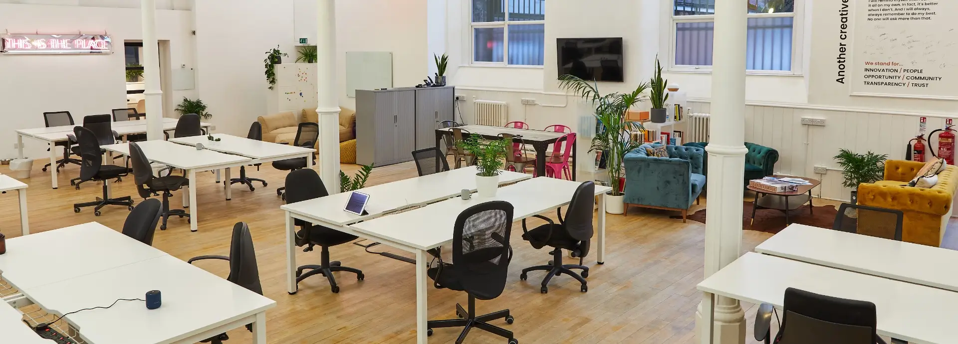 Wide shot of Seventy7 Manchester Office with desks and chairs.