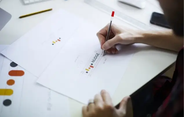 Hand drawing around Nudge logo brand development.