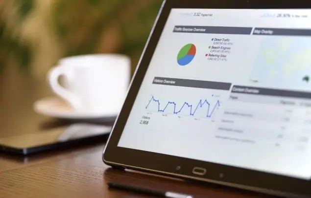 Tablet computer showing blurred image of website design statistics.