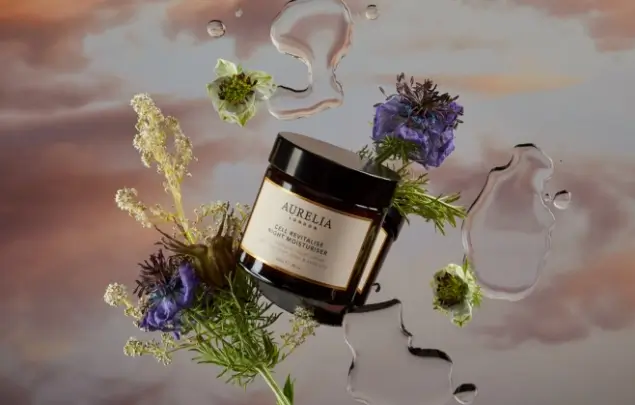 Aurelia moisturiser pot with plants and sky background.