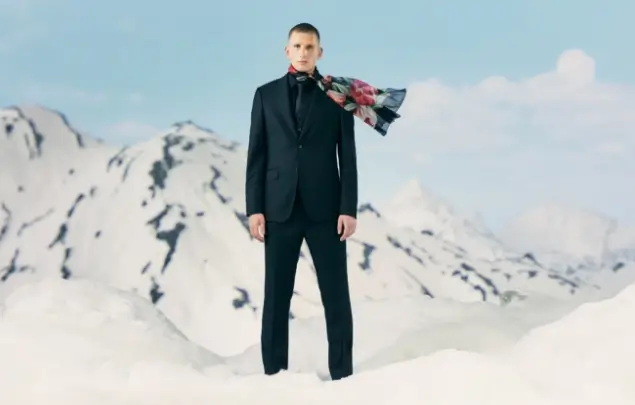 Male model wearing suit in snowy landscape