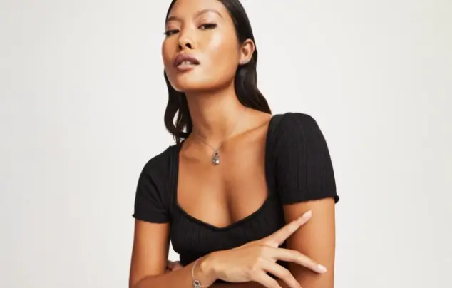 Lady posing in front of white background.