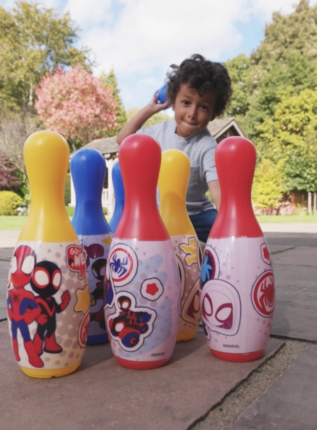 Young child playing outdoors with Sambro's Disney skittles set.